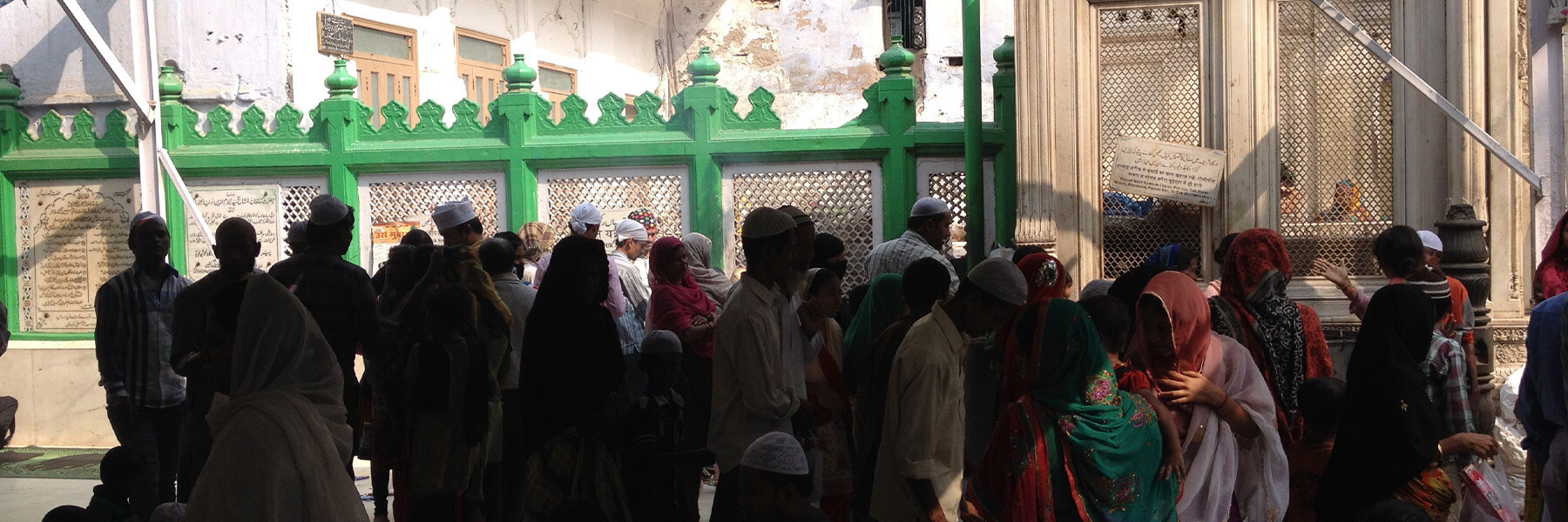 People standing in front of the Nizamuddin Dargah in Delhi, India